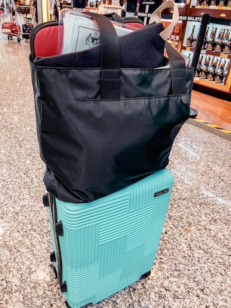 Alpaka Elements Tote on luggage during travel